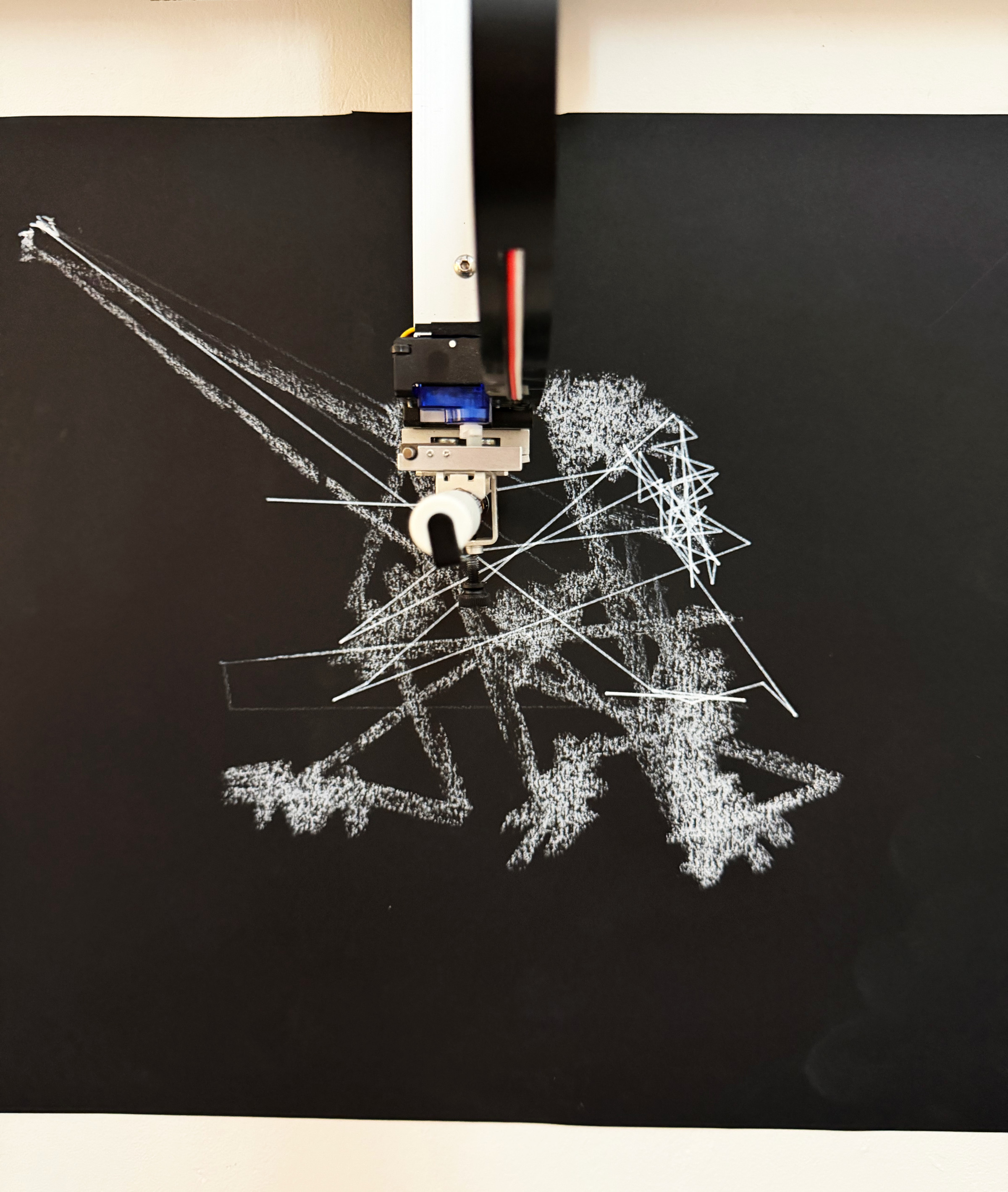 AxiDraw drawing white traces onto black paper